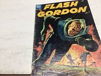 Front cover of Flash Gordon issue #2 comic showing Flash Gordon in green space suit and helmet with yellow title and Dell logo.