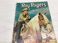 Front cover of Roy Rogers comic book showing Roy Rogers holding a dog on a horse