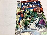 Front cover of Marvel Spider-Man comic issue #34 featuring Spider-Man fighting lizard enemies with title and price.
