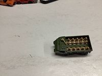Photo showing the green Lesney Personnel Carrier toy truck with 10 tan molded personnel figures seated inside.