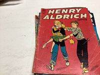 Stack of various vintage comic books with Henry Aldrich Comics on top, red cover