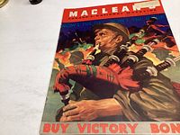 Cover of the April 15 1944 issue of Macleans Magazine showing a soldier playing bagpipes with a call to buy victory bonds.