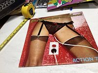 Front cover showing provocative design with woman's legs in lingerie and stockings.