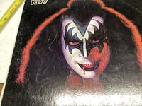 Close-up of the front album cover showing Gene Simmons in black and white makeup with red highlights.