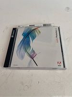 Front of jewel case with Adobe Photoshop CS2 cover art showing colored feather design