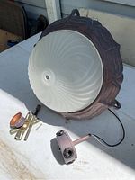 Overall view of the 14-inch ceiling light fixture showing frosted glass dome and metal frame, placed on table with mounting hardware nearby.