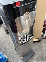 Full frontal view of the Whirlpool water dispenser showing the dispenser front, digital display and drip tray