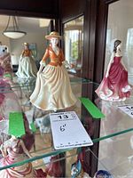 Front view of the Royal Doulton Autumn Stroll figurine showing detailed porcelain craftsmanship and glossy finish.