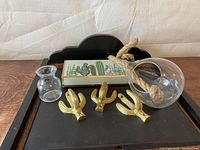Lot arranged on a wooden tray showing cactus hooks, cactus pen station, small glass bud vase and hanging glass vase.