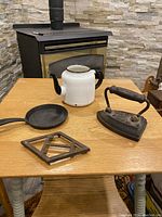 Overview of all four items on wooden table in front of stone background with stove behind