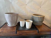 Photo showing all four planters on a wooden surface with white background