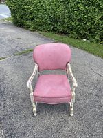 Front facing photo of pink Queen Anne style chair showing upholstery and chair frame.