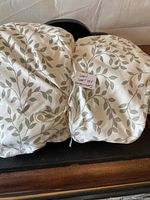 Two folded sheets with leaf pattern tied with string and label showing 'Queen Sheet Set Fitted + Flat'