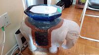 Pair of ceramic elephant garden seats with cobalt blue octagonal tops in room