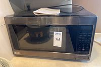 Front view of LG microwave oven model LCRT2010 showing glass door and control panel on right side with label.
