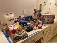 Wide view of countertop with all items including boxes of paraffin bath, facial sauna, soaps, hair tools, and medical supplies
