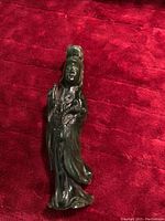Front view of antique solid jade carved female figure sculpture showing detailed facial expression, hair bun, and flowing robes.