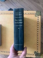 Front view of book's spine showing title, author, and publisher.