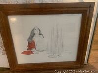Framed signed oil painting on canvas showing woman with red cloth and light background.