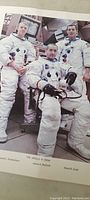 Clear image of Apollo 9 crew in spacecraft control setting, showing astronauts in suits and control panels, with names at bottom.