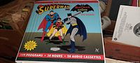 Vinyl case cover with colorful Superman, Batman and Robin illustration, highlighting 119 programs, 30 hours, 20 cassettes.