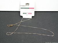 Full chain necklace with package label showing brand Primavera and made in Italy text on white background.