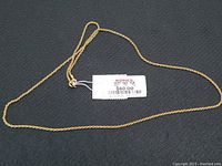 Full length of the 20-inch chain laid out with a price tag showing $60.00.