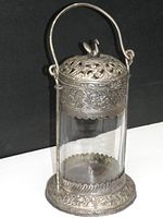 Front angled view of the pickle castor showing silver plate details and clear glass jar