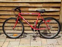 Side profile showing the full red Pathfinder Gooo 26-inch mountain bike with tires and seat.