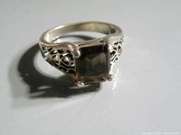 Close-up photo of the sterling silver ring with smoky quartz gemstone showing detailed filigree sides and stone setting.
