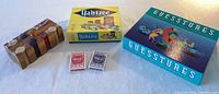 Lot including boxed Yahtzee game, Guesstures box, two decks of playing cards, and wooden poker chips
