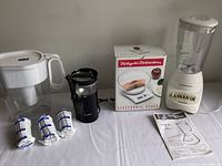 Photo showing all items including the Brita pitcher, Mr. Coffee grinder, Weight Watchers scale in box and Hamilton Beach blender