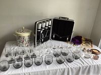 Full view of the barware set including glasses, ice bucket, and carrying case with tools.