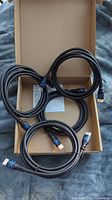 Four black Bluerigger HDMI cables, about 6.6ft long each, coiled inside an open cardboard box.
