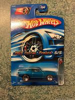 Full view of the Hot Wheels Redline 1969 Pontiac Firebird sealed on card with visible branding and series number.
