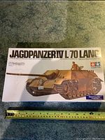 Top view of sealed Tamiya Jagdpanzer IV L/70 Lang tank model kit box with measuring tape showing box length.