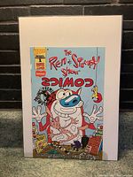 Front cover photo of The Ren & Stimpy Show comic book premium gold edition showing the characters Ren and Stimpy with bright colorful cartoon art.