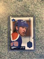 Front view of Wayne Gretzky Limited Edition Card in protective case showing player profile in Edmonton Oilers gear with number 99 and numbering 0626/1999 visible on card.