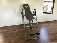 Full view of Body Champ inversion table showing frame, padded board and foot rests