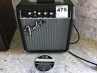 Front view of the Fender Frontman 10G guitar amplifier showing the input, gain, volume, treble, and bass controls along with the Fender logo and grille cloth.