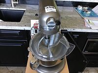 Assembled mixer with bowl and pouring shield on countertop
