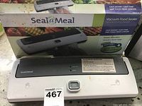 Seal a Meal vacuum food sealer with original packaging box, showing product branding and device details.