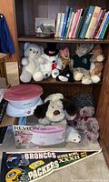 Photo showing paraffin wax spa, stuffed animals, Broncos Packers pennant, and books on shelves