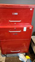 Red Sears Craftsman tool chest stacked with top chest and bottom cabinet, showing overall condition with scratches and wear.