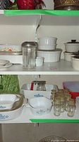 Shelves filled with multiple white cookware dishes with lids, some with blue floral patterns, glass jars and small casserole dishes