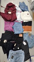 Full view of clothing lot including hoodie, jeans, sweaters, and assorted tops