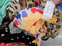 Close-up of colorful abstract cotton scarf with visible Sacha label