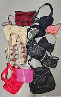 Top-down photo showing all 12 purses in a group, highlighting variety including leather and fabric materials in multiple colors and styles.
