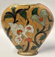Front view showing embossed floral enamel pattern on brass vintage vase