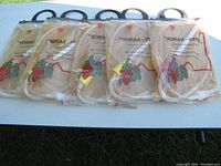 Five packages of Vorax VINO extendable siphon hoses displayed side by side on a table, showing product packaging and hose contents.